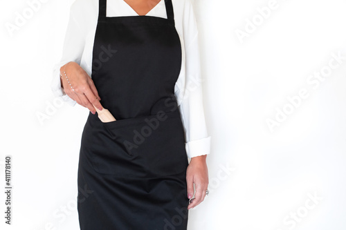 Leinwand Poster Woman in apron holding a roller