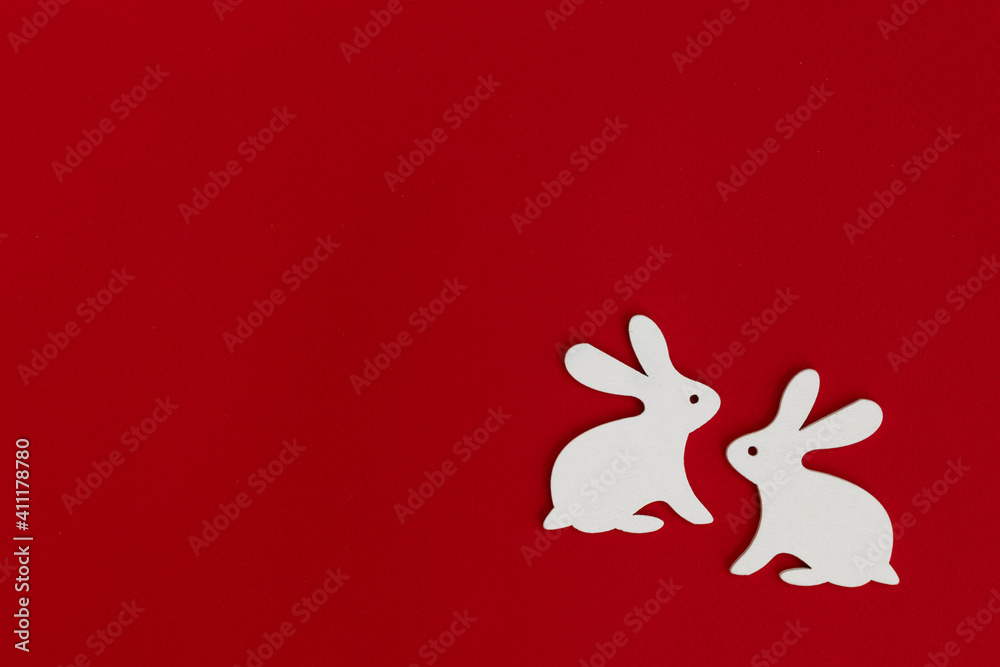 Obraz premium Happy Easter! Easter decoration - Easter bunnies on a bright red background.