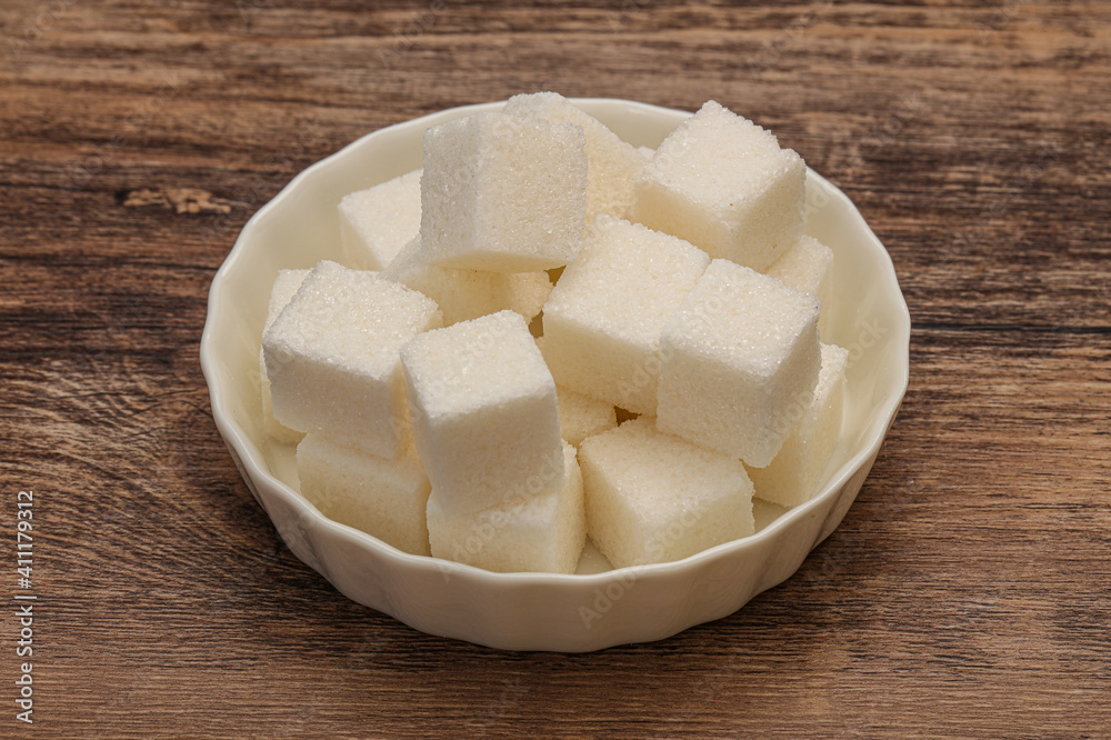 Refined white sugar cubs in the bowl Refined white sugar cubs in the bowl