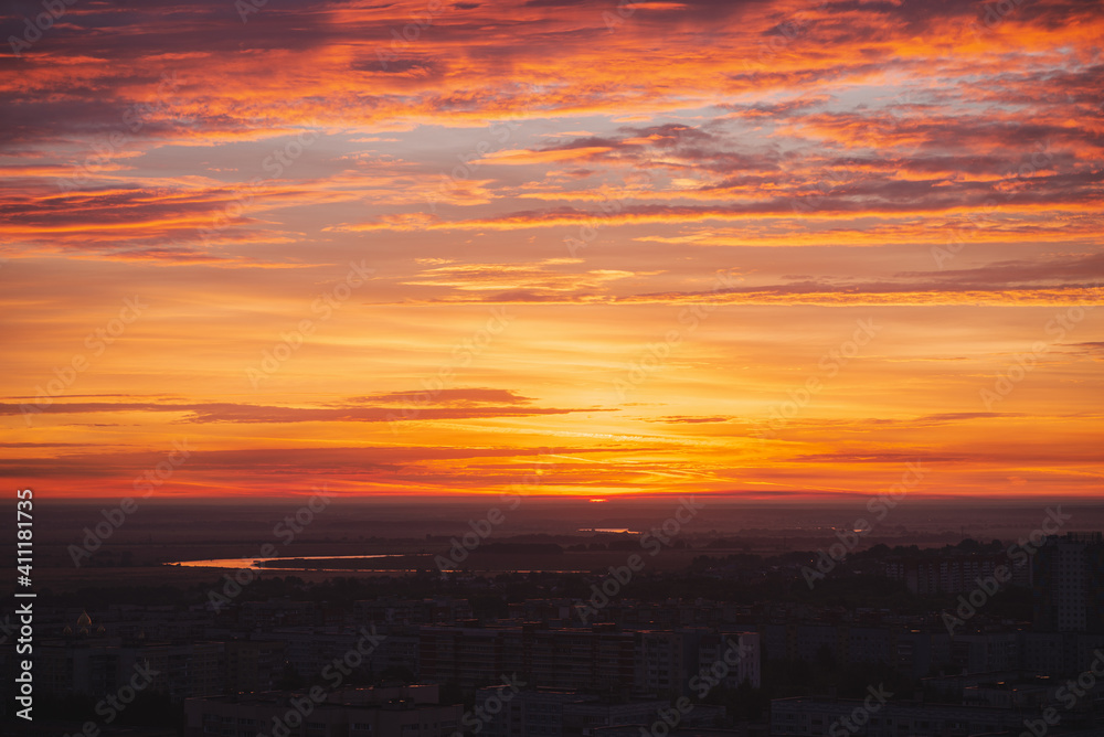 Beautiful orange sunset over the city of Ryazan in summer. Sunrise over the city in the fog in summer