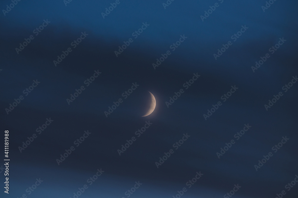 The moon among the stars and clouds
