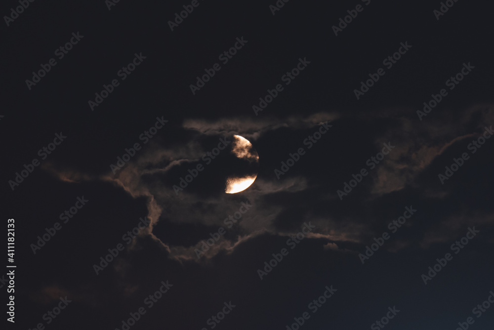 The moon among the stars and clouds