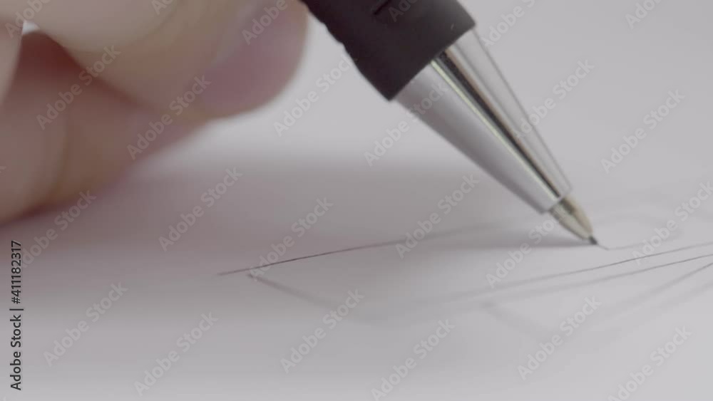 Extreme close-up shot of a hand drawing a technical draft. The camera passes the hand in a straight line with the focus shifting continuously. Extreme close-up shot of a hand drawing a technical draft. The camera passes the hand in a straight line with the focus shifting continuously.