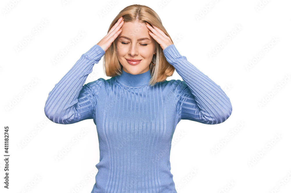 Young blonde woman wearing casual clothes suffering from headache desperate and stressed because pain and migraine. hands on head. Young blonde woman wearing casual clothes suffering from headache desperate and stressed because pain and migraine. hands on head.