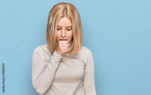 Young blonde woman wearing casual clothes feeling unwell and coughing as symptom for cold or bronchitis. health care concept.