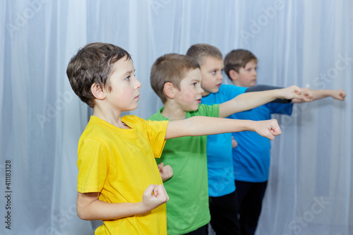 Boys in colorful T-shirts hit the punch