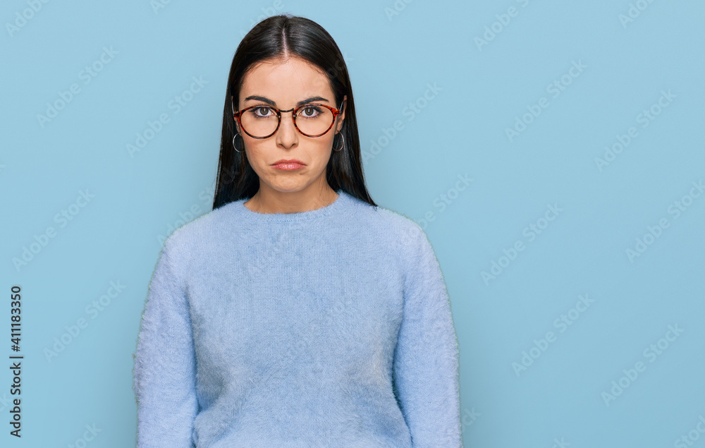 Young hispanic woman wearing casual clothes and glasses depressed and worry for distress, crying angry and afraid. sad expression. Young hispanic woman wearing casual clothes and glasses depressed and worry for distress, crying angry and afraid. sad expression.