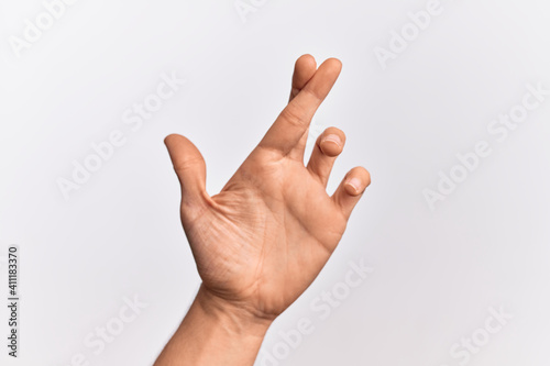 Hand of caucasian young man showing fingers over isolated white background gesturing fingers crossed, superstition and lucky gesture, lucky and hope expression