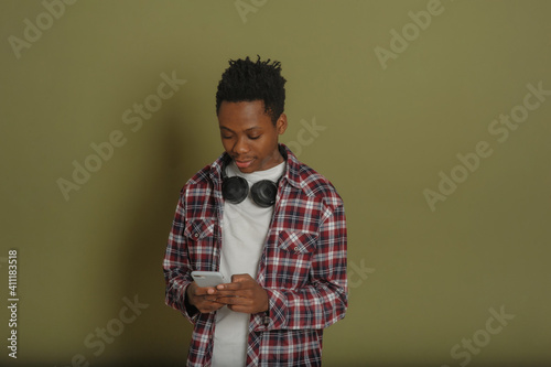 young african american guy talking on the phone on a green background