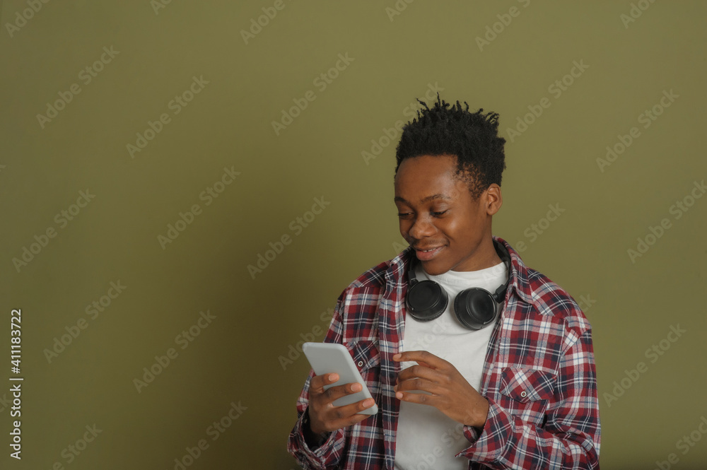 young african american guy talking on the phone on a green background