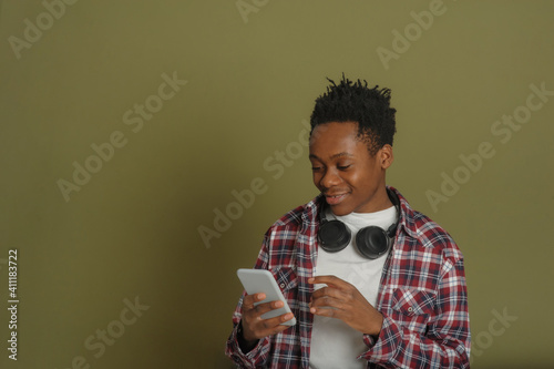young african american guy talking on the phone on a green background