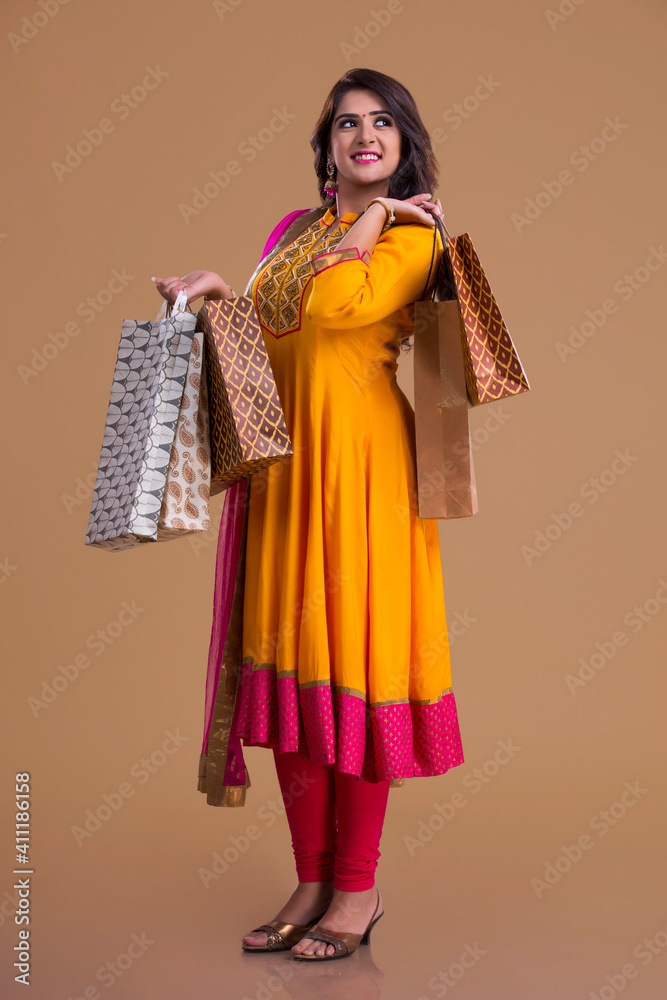 woman holding shopping bags and smiling	