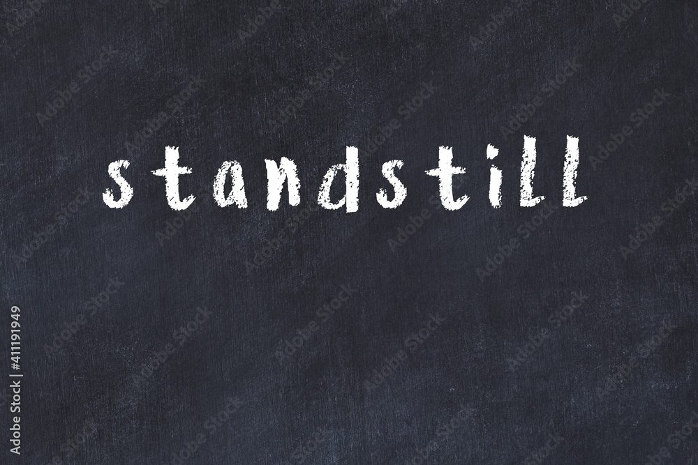 Fotografie Black chalkboard with inscription standstill on in