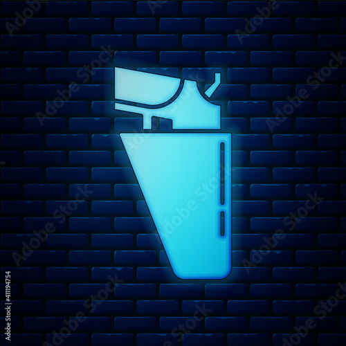 Glowing neon Revolver gun in holster icon isolated on brick wall background. Vector.
