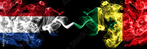 Netherlands vs Senegal smoky mystic flags placed side by side. Thick colored silky abstract smoke flags.