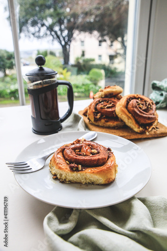 Cinnamon rolls buns on a white plate simple background  photo