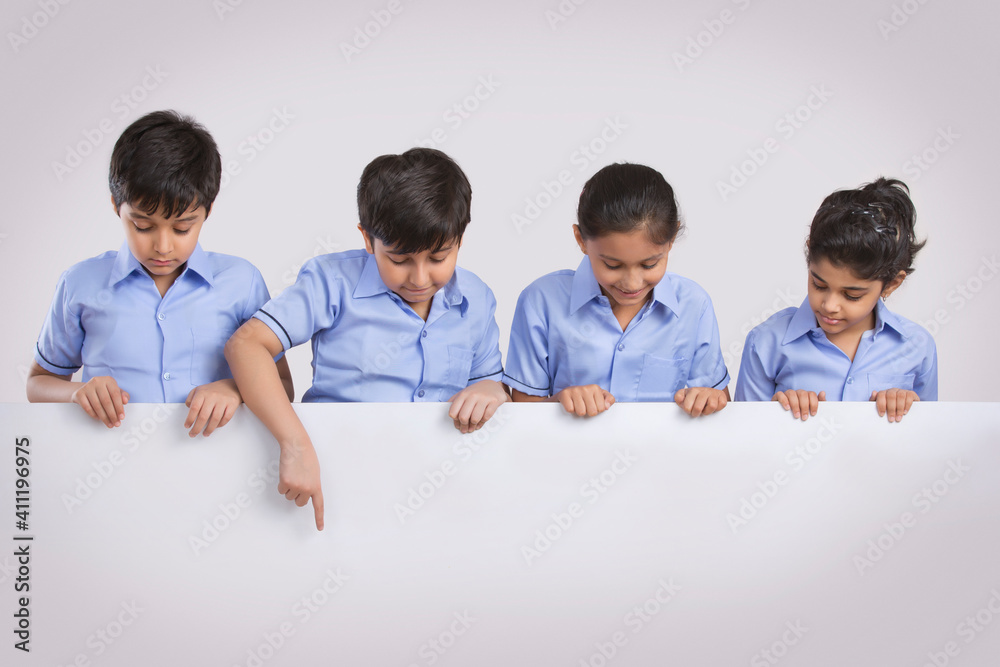 portrait of school children pointing at something portrait of school children pointing at something
