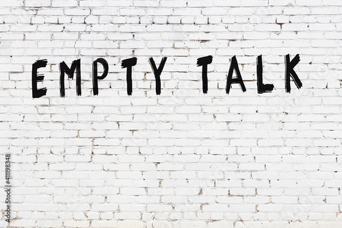 Inscription empty talk painted on white brick wall