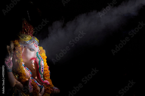 idol of lord Ganesh in a dark room 
