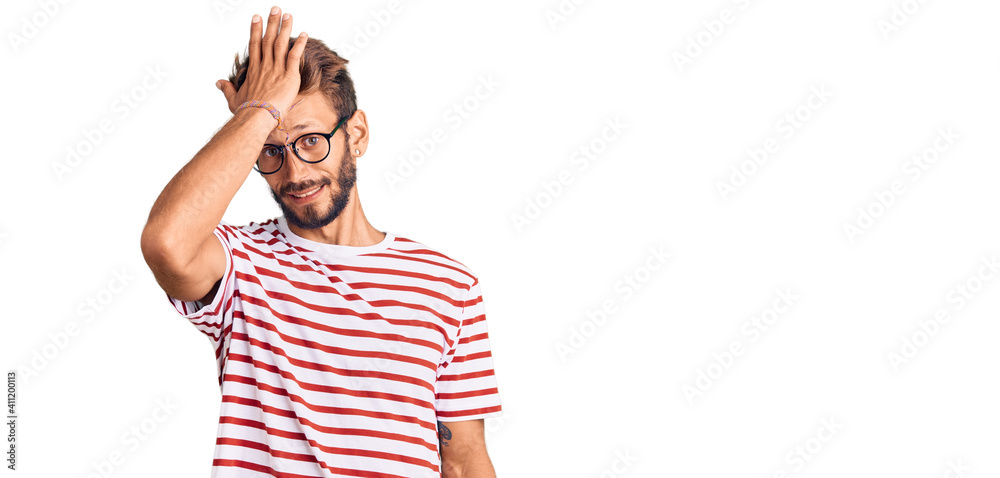 Handsome blond man with beard wearing casual clothes and glasses surprised with hand on head for mistake, remember error. forgot, bad memory concept. Handsome blond man with beard wearing casual clothes and glasses surprised with hand on head for mistake, remember error. forgot, bad memory concept.