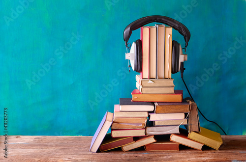 audio book concept with large heap of books and vintage headphones,literature,entertainment,education, good copy space photo