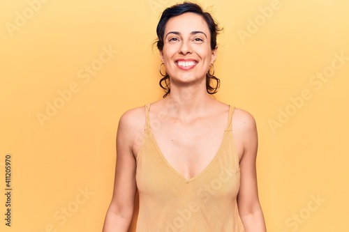 Young beautiful hispanic woman wearing casual clothes looking positive and happy standing and smiling with a confident smile showing teeth