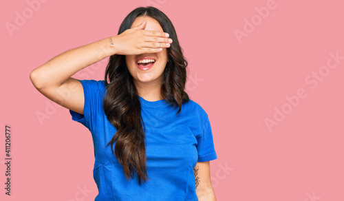 Beautiful brunette young woman wearing casual clothes smiling and laughing with hand on face covering eyes for surprise. blind concept.