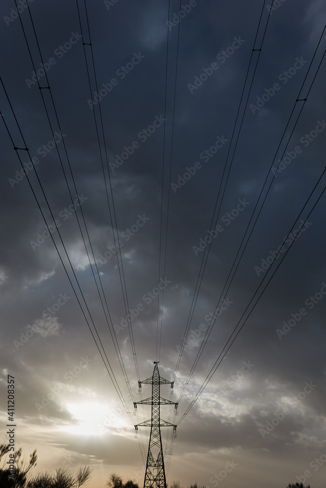The last rays of the sun on some high voltage towers in Boadilla del Monte. Madrid's community. Spain