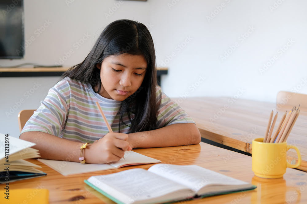 girl student studying writing notes doing homework. learning education at school girl student studying writing notes doing homework. learning education at school
