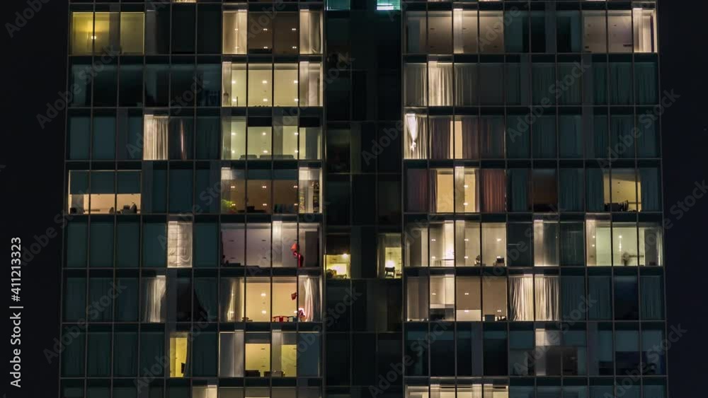 Blinking light in window of the multi-storey building of glass and steel lighting and people within timelapse close up view. Dubai, UAE. Tilt up Blinking light in window of the multi-storey building of glass and steel lighting and people within timelapse close up view. Dubai, UAE. Tilt up