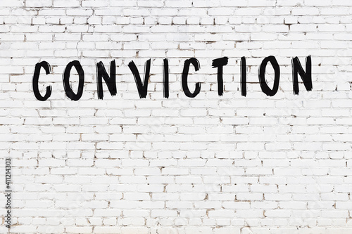 Inscription conviction painted on white brick wall