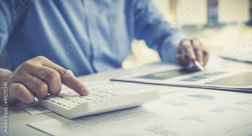 Financial businessman calculating corporate income tax data And analyzing charts of financial stocks that are in good condition with growth and progress, Investment in finance and accounting.