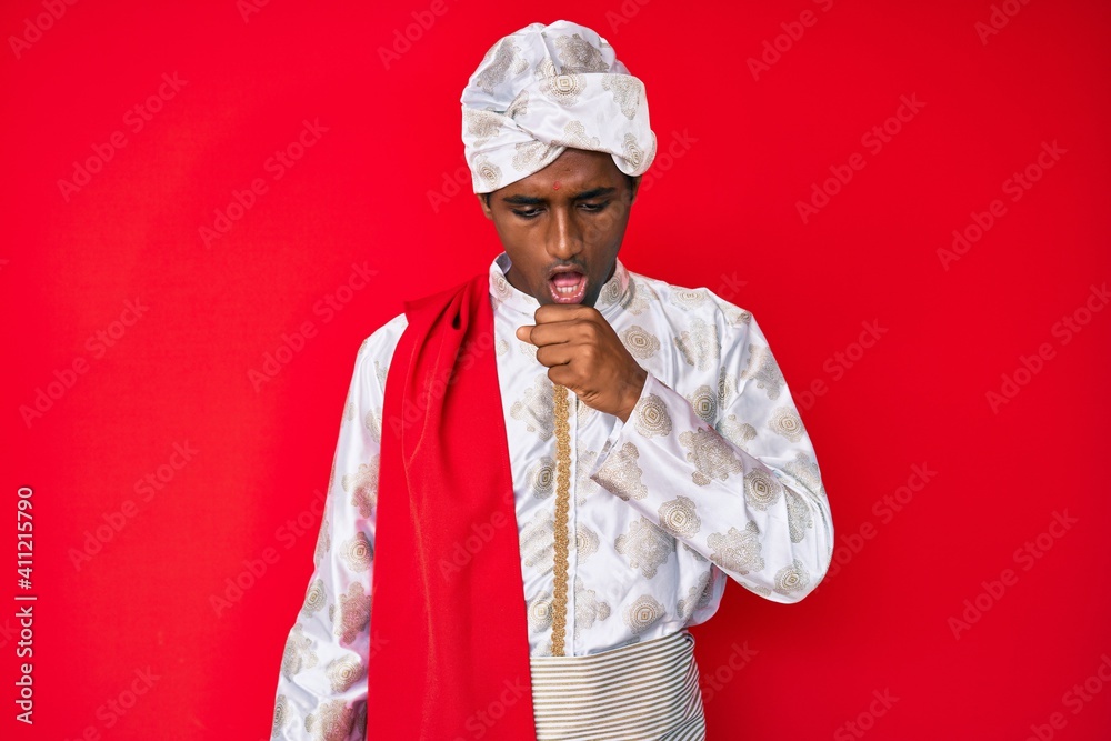 Handsome indian man wearing tradition sherwani saree clothes feeling unwell and coughing as symptom for cold or bronchitis. health care concept. Handsome indian man wearing tradition sherwani saree clothes feeling unwell and coughing as symptom for cold or bronchitis. health care concept.