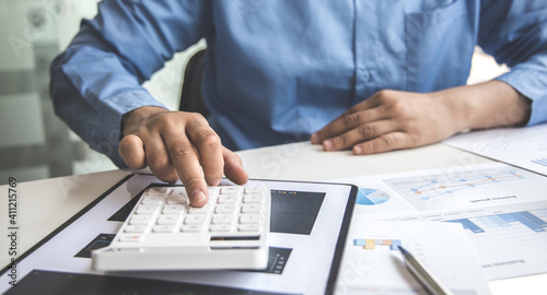 Financial businessman calculating corporate income tax data And analyzing charts of financial stocks that are in good condition with growth and progress  Investment in finance and accounting.