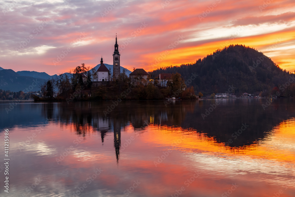 Cozy sunrise on Lake Bled against the backdrop of the castle in the Julian Alps in the Tirglav National Park