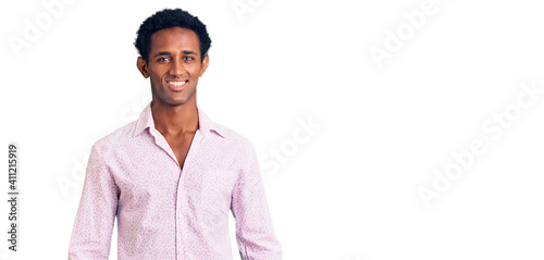 African handsome man wearing casual pink shirt with a happy and cool smile on face. lucky person.