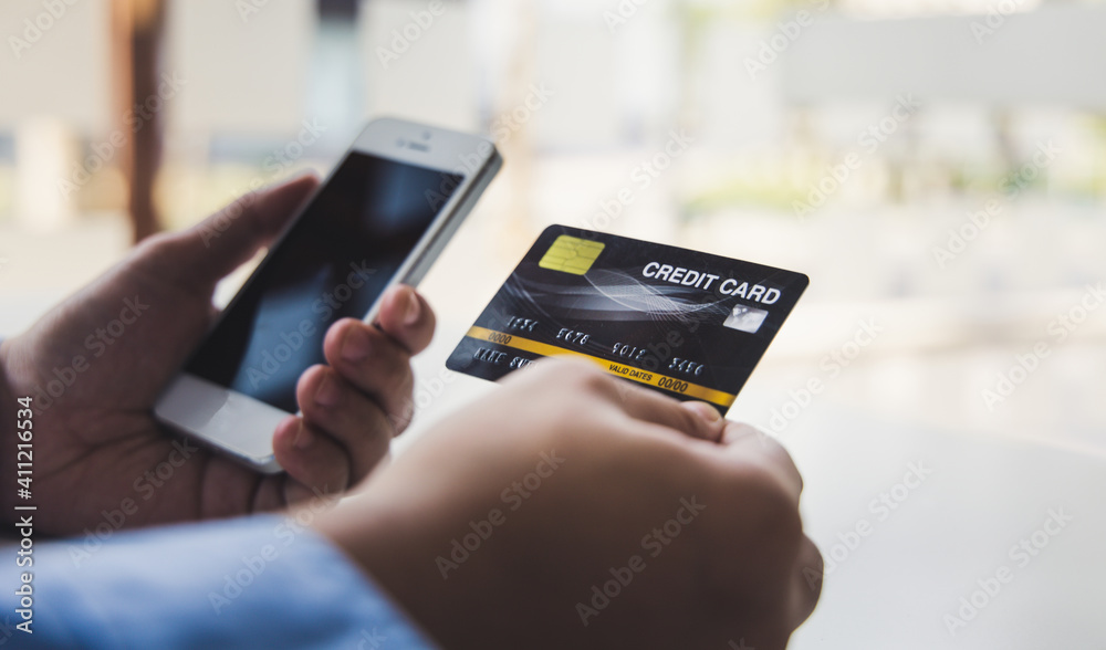 Businessman use mobile phones to register for security Online with a credit card to buy products online through application, Online shopping or Internet technology concept. Businessman use mobile phones to register for security Online with a credit card to buy products online through application, Online shopping or Internet technology concept.