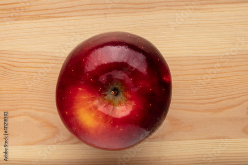 Signle red apple on a wooden background photo