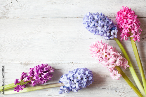 Wooden white background with hyacinth flowers and space for text photo