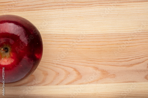 Signle red apple on a wooden background