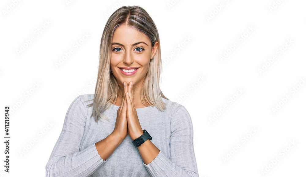 Beautiful blonde woman wearing casual clothes praying with hands together asking for forgiveness smiling confident. Beautiful blonde woman wearing casual clothes praying with hands together asking for forgiveness smiling confident.