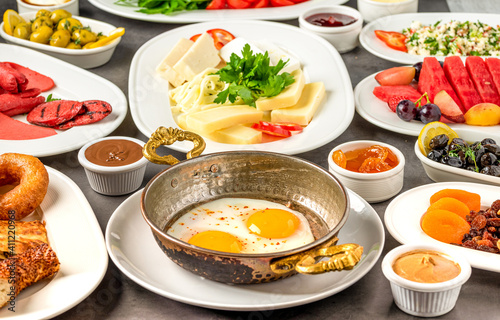 Traditional Turkish Breakfast served with traditional turkish tea on stone table