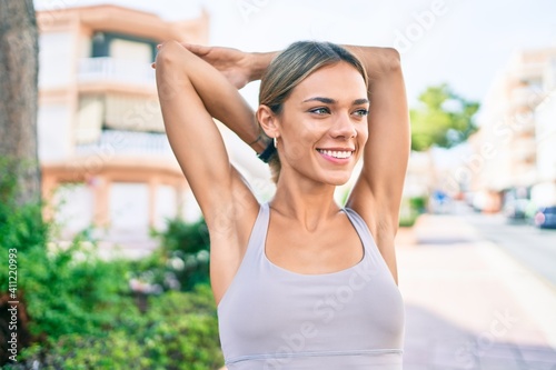 Free Download Young cauciasian fitness woman wearing sport clothes training and stretching outdoors - GFXLoad