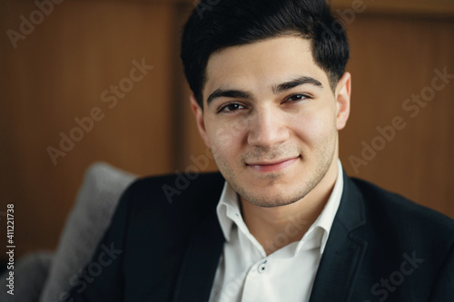 portrait of a professional trader, a man of European appearance in a business suit. works sitting in a new stylish office on the couch. job senior economist