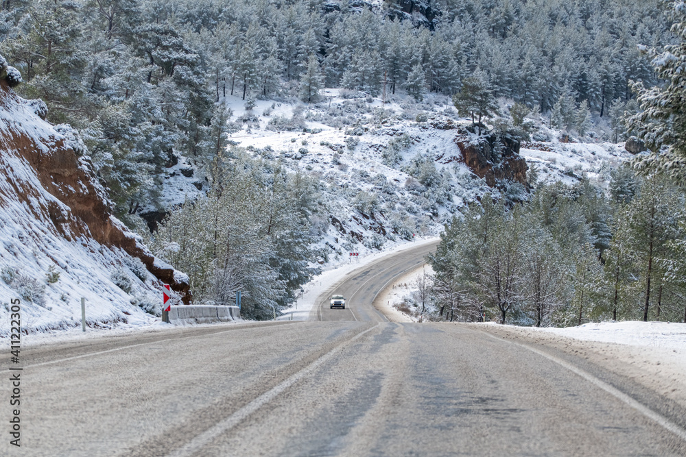 Fototapeta premium scenic view of the road in the forest with snow covered.