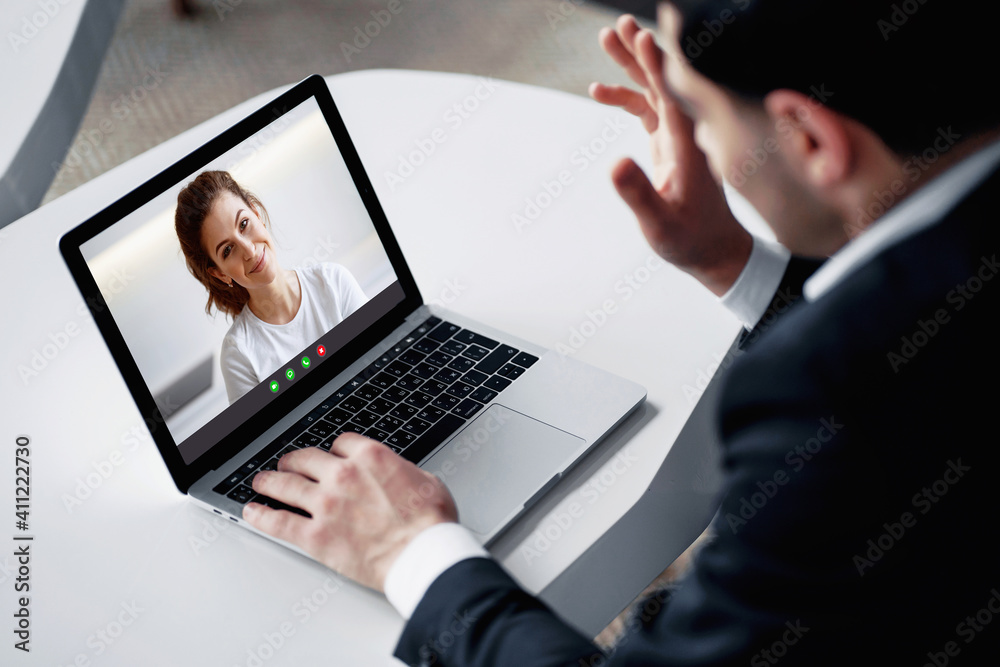 a dark-haired man of European appearance in a black business suit. he sits in a modern office and communicates on a social network on a laptop. my favorite job is senior economist at a bank. a dark-haired man of European appearance in a black business suit. he sits in a modern office and communicates on a social network on a laptop. my favorite job is senior economist at a bank.