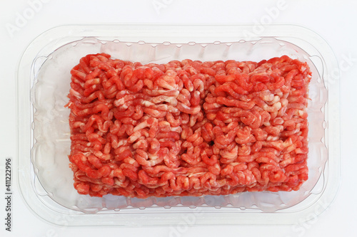 Fresh mince meat in transparent plastic box on white background 
