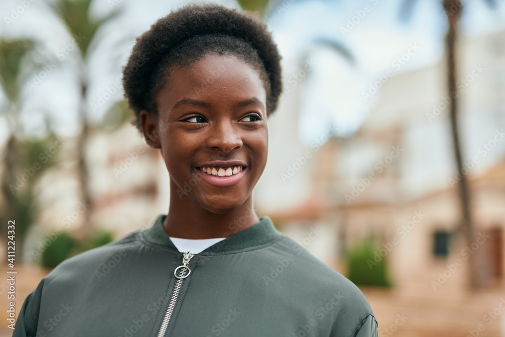 Young african american girl smiling happy standing at the park. Young african american girl smiling happy standing at the park.