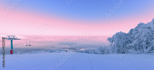 Ski resort, beautiful morning landscape. Ski trail trees and sky. photo