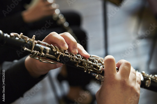 Closeup of a person playing the oboe, indoors